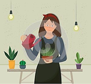 A happy smiling young woman watering house plants, domestic life concept