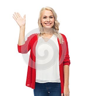 Happy smiling young woman waving hand over white