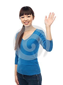 Happy smiling young woman waving hand over white