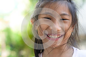 Happy smily face Asian girl with bokeh background.