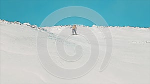 Happy snowboarder having fun snowboarding backcountry on a sunny winter day in snowy mountains. Video. Extreme freeride