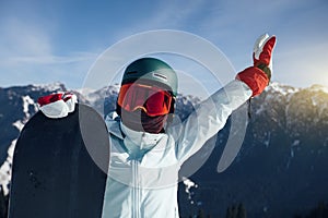 Happy snowboarder with snowboard