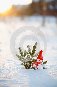 Happy snowman standing in winter christmas landscape.Snow background