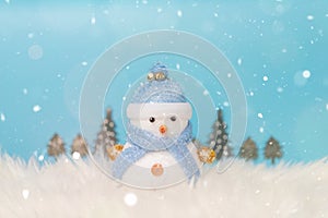 Happy snowman standing in winter christmas snow background. Merry christmas and happy new year greeting card with copy-space.