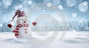 Happy snowman in winter secenery photo