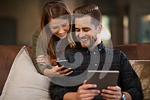 Happy, sofa and couple with phone and tablet for social media meme, internet joke and show videos. Home, living room and