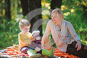 Happy son with mother relax in autumn forest. Sunny weather. Healthy food. Mother love small child. Spring mood. Happy