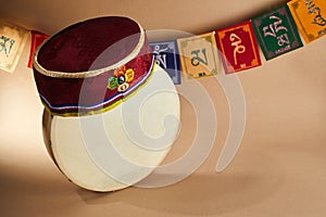 Happy Sonam Losar lunar New Year festival of Nepal. Traditional Tamang topi hat, hand drum and flags Om mani padme hum.