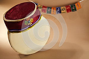 Happy Sonam Losar lunar New Year festival of Nepal. Traditional Tamang topi hat, hand drum and flags Om mani padme hum.