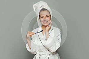 Happy spa woman with cute smile, white teeth, toothbrush and toothpaste on white