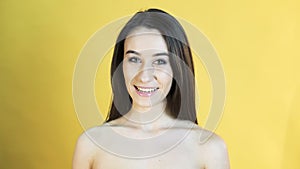 Happy speaking girl on yellow background in 4K