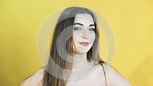 Happy speaking girl on yellow background in 4K