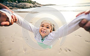 Happy, spin and portrait of child at the beach for travel, support and fun. Swinging, smile and summer with girl and
