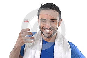 Happy sport man posing corporate with water and towel for fitness center