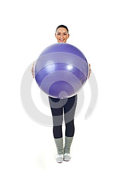 Happy sport woman holding pilates ball