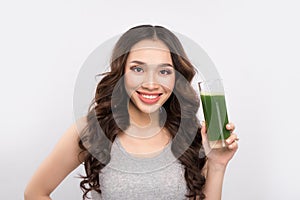 Happy sportswoman showing healthy fruit and vegetables drink.