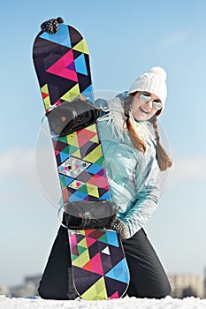 Happy sportswoman with snowboard