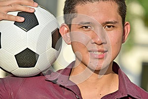 Happy Sporty Asian Person With Soccer Ball