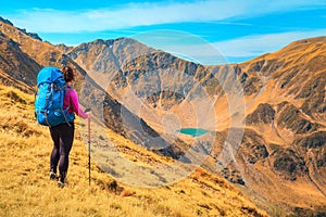 Happy sporty backpacker hiker woman in mountains, Carpathians, Transylvania, Romania