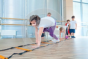 Happy sporty children in gym. Kids exercises