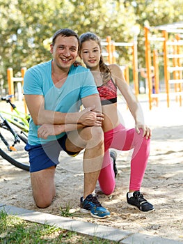 Happy sporty father and preteen girl