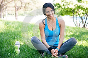 Happy sporty woman resting outdoors