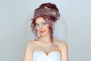 Happy spouse. Beauty portrait of bride wearing fashion wedding dress with luxury delight make-up and hairstyle  on light