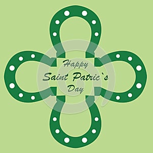 Happy St. Patrick`s Day with horseshoes in the shape of a green clover