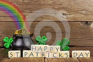 Happy St Patricks Day blocks with decor against wood