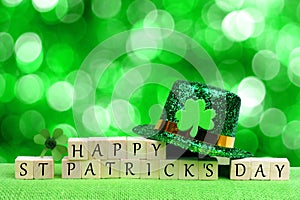 Happy St Patricks Day blocks, leprechaun hat over twinkling green