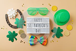 Happy St Patricks day concept with lightbox, lucky charms, shamrock and leprechaun hat. Top view