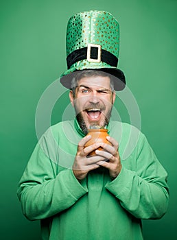 Happy St Patricks Day concept with pot of gold. Man on green background celebrate St Patricks Day. Patricks Day Pot of photo