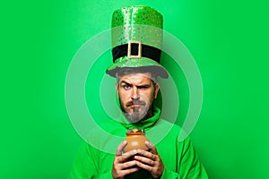 Happy St Patricks Day concept with pot of gold. Pot with money for St. Patrick`s Day. Patricks Day Pot of Gold and photo