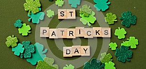 Happy St Patricks Day wooden blocks with shamrocks decor on a green background