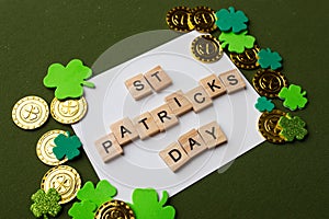 Happy St Patricks Day wooden blocks with shamrocks decor on a green background