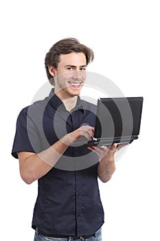 Happy standing man typing on a laptop