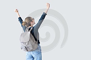 Happy student with arms raised on air