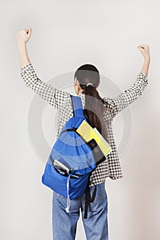 Happy student with arms raised on air