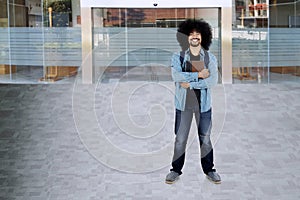 Happy student with book standing