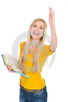 Happy student girl with book rising hand to answer