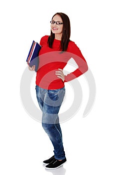 Happy student girl is holding folders and smiling.