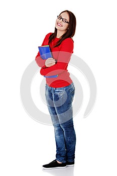 Happy student girl is holding folders and smiling.