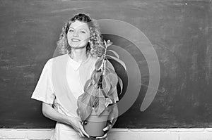 happy student girl with plant at blackboard. tree of knowledge. school learning ecology. school nature study