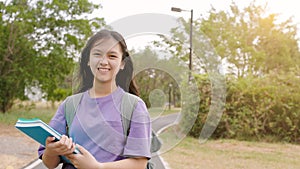 Happy student girl walking in the school