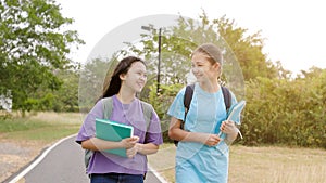 Happy student girls walking and talking in the school