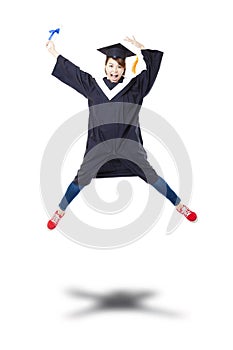 Happy student in graduate robe jumping against white back