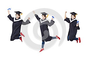 Happy student in graduate robe jumping against white back