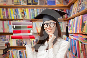Happy Student with Graduation Cap Holding Books