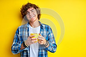 Happy student guy with cup of tea