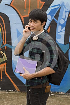 Happy student holding books with backpack